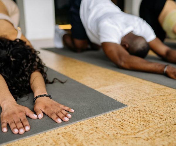 Group of diverse people in a yoga class focusing on their practice.